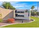 Community signage with the name Rancho Mirage and address, set against a backdrop of lush landscaping and blue skies at 2400 E Baseline Ave # 228, Apache Junction, AZ 85119
