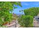 Lush yard with a white fence, mature trees, and distant mountain views, offering a serene setting at 2400 E Baseline Ave # 228, Apache Junction, AZ 85119