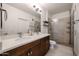 Bathroom boasting double sinks, quartz countertops, modern fixtures, and walk-in shower with glass door at 2511 W Queen Creek Rd # 337, Chandler, AZ 85248