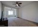 Comfortable carpeted bedroom featuring a ceiling fan, natural light, and easy access to a connected room at 2511 W Queen Creek Rd # 337, Chandler, AZ 85248