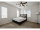 Carpeted bedroom featuring a ceiling fan, natural light, and bed with headboard at 2511 W Queen Creek Rd # 337, Chandler, AZ 85248