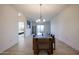 Dining room with modern light fixture and sliding door access to the balcony at 2511 W Queen Creek Rd # 337, Chandler, AZ 85248