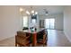 Bright dining room with modern light fixture and access to outdoor balcony at 2511 W Queen Creek Rd # 337, Chandler, AZ 85248
