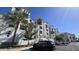 Condominium exterior with parking and palm trees with blue sky at 2511 W Queen Creek Rd # 337, Chandler, AZ 85248