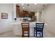 Bright eat-in kitchen with quartz countertops, stainless appliances, and dark wood cabinets at 2511 W Queen Creek Rd # 337, Chandler, AZ 85248