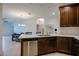 Kitchen with stainless steel appliances, white countertops, and dark wood cabinets at 2511 W Queen Creek Rd # 337, Chandler, AZ 85248