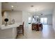 Bright, open-concept living space with modern kitchen island and dining area with outdoor access at 2511 W Queen Creek Rd # 337, Chandler, AZ 85248
