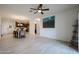 Spacious living room with tiled flooring, ceiling fan, and open concept kitchen and dining area at 2511 W Queen Creek Rd # 337, Chandler, AZ 85248