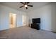 Bedroom with carpet, ceiling fan, television, and access to the bathroom and additional room at 2511 W Queen Creek Rd # 337, Chandler, AZ 85248