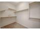 Walk-in closet features carpeted flooring and wood shelving on all walls at 2511 W Queen Creek Rd # 337, Chandler, AZ 85248