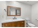 Charming bathroom featuring wood vanity, white marble countertop, and patterned mirror at 2614 E Mountain View Rd, Phoenix, AZ 85028