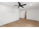 Comfortable bedroom with ceiling fan, wood flooring, and ample space at 2614 E Mountain View Rd, Phoenix, AZ 85028