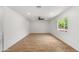 Bright bedroom featuring wood-look floors, a ceiling fan, and a window offering natural light at 2614 E Mountain View Rd, Phoenix, AZ 85028