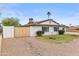 Charming single-story home with a well-maintained front yard, mature landscaping, and a circular driveway at 2614 E Mountain View Rd, Phoenix, AZ 85028
