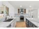Modern kitchen with white cabinets, stainless steel appliances, marble countertops, and an island at 2614 E Mountain View Rd, Phoenix, AZ 85028