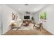 Bright living room with wood floors, stylish furniture, ceiling fan, and a large window at 2614 E Mountain View Rd, Phoenix, AZ 85028