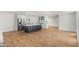 Open-concept living room flowing into a kitchen, showcasing stainless steel appliances and wood-look floors at 2614 E Mountain View Rd, Phoenix, AZ 85028