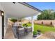 Back patio featuring an outdoor living area with seating and a view of the landscaped backyard at 2614 E Mountain View Rd, Phoenix, AZ 85028