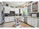 Bright kitchen features white cabinets, dark backsplash, stainless steel appliances, and a kitchen island at 26271 N 46Th St, Phoenix, AZ 85050