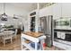 Open layout shows kitchen with adjacent dining and living spaces with stainless appliances and island at 26271 N 46Th St, Phoenix, AZ 85050