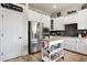 Well-appointed kitchen featuring white cabinets, stainless steel appliances, and a stylish backsplash at 26271 N 46Th St, Phoenix, AZ 85050
