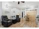 Comfortable living room with wood floors, leather recliners, and an open dining area at 26271 N 46Th St, Phoenix, AZ 85050