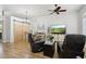 Cozy living area with wooden floors, leather seating, and views of the dining space at 26271 N 46Th St, Phoenix, AZ 85050