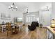 Open-concept living space featuring wood floors, a dining area, and comfortable leather seating at 26271 N 46Th St, Phoenix, AZ 85050