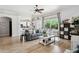 Open-concept living area with modern decor, wood flooring, and seamless flow to the kitchen at 26271 N 46Th St, Phoenix, AZ 85050