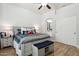 Spacious main bedroom boasts wood floors, shiplap accent wall, and ensuite bathroom entrance at 26271 N 46Th St, Phoenix, AZ 85050