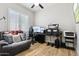 Well-lit office space with a comfortable couch, multiple monitors, and lots of storage at 26271 N 46Th St, Phoenix, AZ 85050
