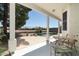 Covered patio with table and chairs overlooking the pool and landscaped backyard at 2641 E Brooks St, Gilbert, AZ 85296