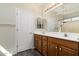 Bathroom featuring double sinks, wood cabinets, and bright lighting at 2641 E Brooks St, Gilbert, AZ 85296