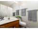 A bathroom featuring a mirrored vanity, toilet, decor, and towel rack at 2641 E Brooks St, Gilbert, AZ 85296