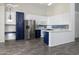 Charming kitchen with stainless steel appliances, blue and white cabinets, and tiled backsplash at 2641 E Brooks St, Gilbert, AZ 85296