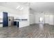 Bright living room with an open floor plan connected to the kitchen, showcasing modern flooring and vaulted ceilings at 2641 E Brooks St, Gilbert, AZ 85296