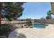 Inviting pool with rock features, surrounded by a well-maintained concrete patio at 2641 E Brooks St, Gilbert, AZ 85296