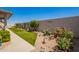 Landscaped backyard showcasing artificial turf, stone accents, and colorful rose bushes at 2839 S Copperwood --, Mesa, AZ 85212