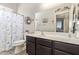 Bathroom with white counter, dark wood cabinets and open door to bedroom at 2839 S Copperwood --, Mesa, AZ 85212