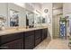Bathroom with double sink vanity, large mirror, and unique glass block accent wall at 2839 S Copperwood --, Mesa, AZ 85212