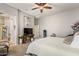 Bright bedroom with ceiling fan, comfortable bed, and view to living area at 2839 S Copperwood --, Mesa, AZ 85212
