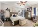 Cozy bedroom featuring a ceiling fan, large bed with decorative pillows, and rustic decor at 2839 S Copperwood --, Mesa, AZ 85212