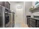 Well-equipped laundry room with modern washer and dryer, storage cabinets, and tiled flooring at 2839 S Copperwood --, Mesa, AZ 85212