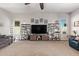 Spacious living room featuring a large TV, decorative shelves, and ample seating at 2839 S Copperwood --, Mesa, AZ 85212