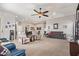 Large living room featuring plush carpet, modern decor, and a ceiling fan at 2839 S Copperwood --, Mesa, AZ 85212
