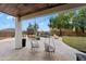 A beautiful outdoor living space with a covered patio, pool, lush lawn, and hanging lounge chairs for relaxing at 28408 N 52Nd Way, Cave Creek, AZ 85331