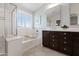 Bathroom featuring a soaking tub and shower combo and dual sinks with picture window at 28408 N 52Nd Way, Cave Creek, AZ 85331