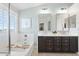Bright bathroom featuring a soaking tub with dual sinks and a view out the window at 28408 N 52Nd Way, Cave Creek, AZ 85331