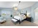 Light and airy main bedroom with a four-poster bed and chandelier lighting at 28408 N 52Nd Way, Cave Creek, AZ 85331