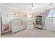 Cute Bedroom with a crib, chair, bookshelf, and ceiling fan at 28408 N 52Nd Way, Cave Creek, AZ 85331